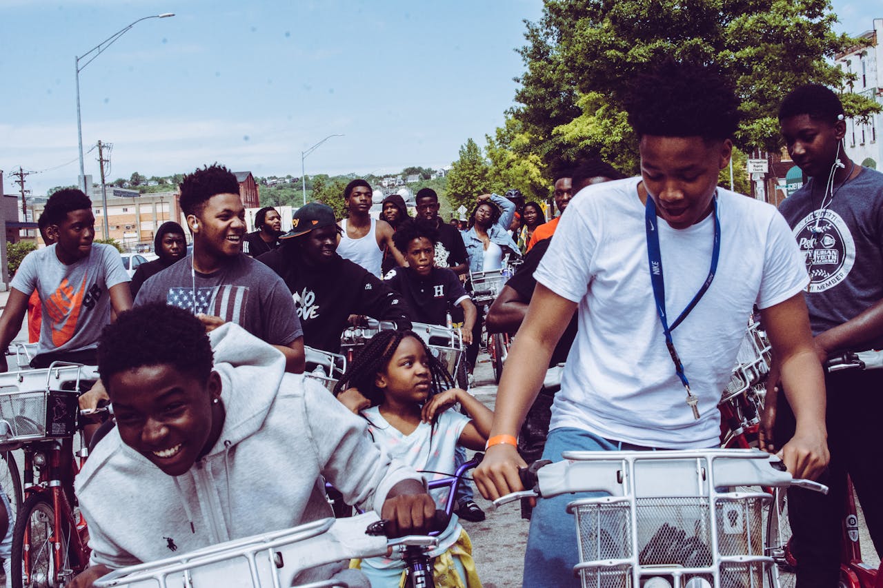 A diverse group enjoying a vibrant bike ride together on a sunny day in Cincinnati.